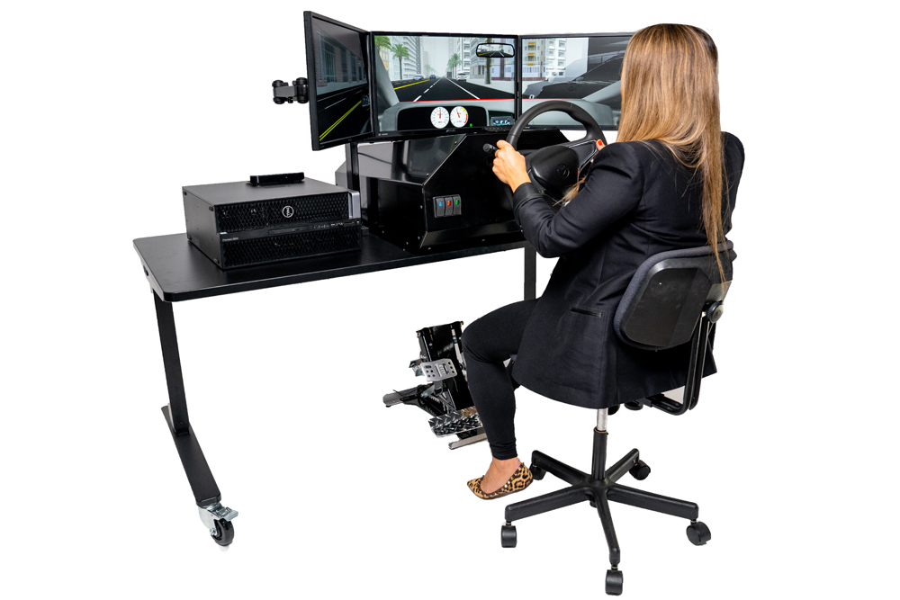 woman sitting at a driving simulator built for OT's