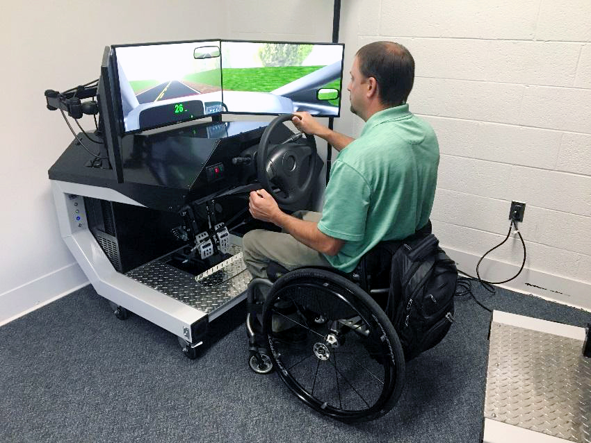 person in wheelchair demonstrating flexibility of the driving simulator
